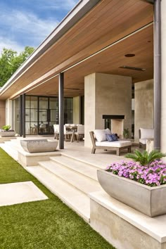 an outdoor living area with grass and flowers