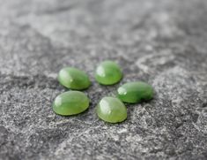 A lovely nephrite jade ring made to order to your size with one of the LOOSE/UNSET oval 6x8mm Canadian nephrite jade cabs shown above, bezel set in 14k yellow gold with a 2mm diameter 14k gold hammered band, with a brushed matte (shown above) or high shine finish. This jade is 100% natural Canadian nephrite from a trusted and reputable nephrite jade source. Some jade sold online as nephrite is actually dyed quartz or serpentine. I am working with Mother Nature and natural stones, therefore exact Green Oval Gemstone Cabochon, Green Gemstone Cabochons, Engagement Ring Custom, Alternative Engagement Ring, Hammered Band, Nephrite Jade, Jade Ring, Alternative Engagement Rings, Gold Band