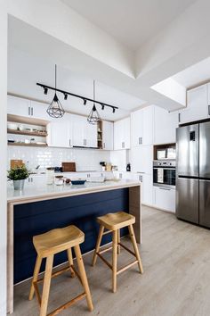 two stools sit in front of the kitchen island