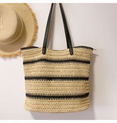 a straw bag hanging on the wall next to a hat