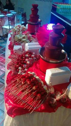 a table topped with lots of different types of desserts and candy bars on sticks