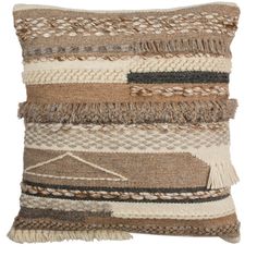 a brown and white pillow with fringes on it