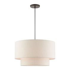 a light fixture with a white drum shade on the bottom and a black metal base