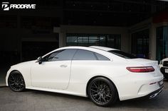 a white car parked in front of a building