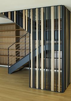 an image of a room with wooden floors and railings on the wall next to stairs