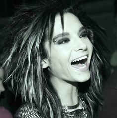 a woman with long hair and piercings laughing