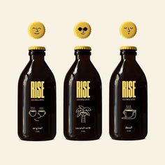 three bottles with faces drawn on them sitting next to each other