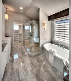 a large bathroom with a walk in shower next to a bathtub