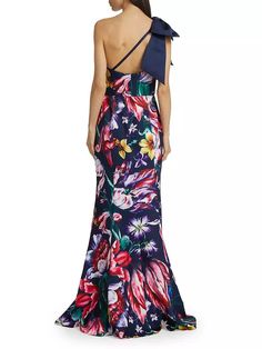 The Marchesa Notte gown showcases a one-shoulder design with an open bow detail at the shoulder, featuring a floral print crafted of crepe..One-shoulder.Sleeveless.Back zip closure.100% polyester.Dry clean only.Imported.SIZE & FIT.About 64' from shoulder to hem.Model measurements: 5'10' tall.Model is wearing a US size Small.The Marchesa Notte gown showcases a one-shoulder design with an open bow detail at the shoulder, featuring a floral print crafted of crepe.One-shoulderSleevelessBack zip closure100% polyesterDry clean onlyImportedSIZE & FITAbout 64' from shoulder to hemModel measurements: 5'10' tallModel is wearing a US size Small Fitted One Shoulder Dress With Floral Print For Evening, One-shoulder Floral Print Prom Dress, One Shoulder Floral Print Prom Dress, Elegant Fitted One Shoulder Dress With Floral Print, Elegant Fitted One Shoulder Floral Dress, One-shoulder Gown For Spring, One Shoulder Gown For Spring, Floral Print One Shoulder Evening Dress, One-shoulder Evening Dress With Floral Print