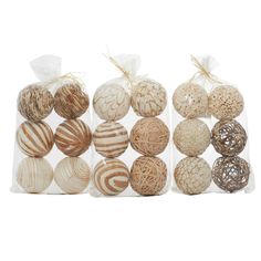 several different types of decorative balls in plastic bags on a white surface with string wrapped around them