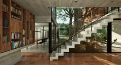 the interior of a modern house with wooden floors and bookshelves