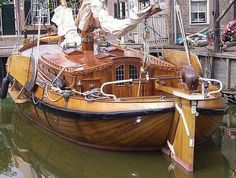 an old wooden boat docked in the water