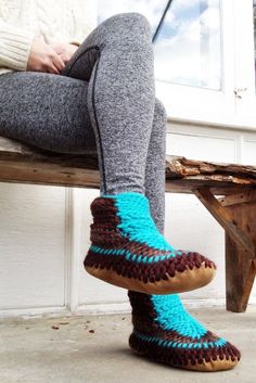 "Custom color slipper requests are welcome: message us with your ideas. Our demi-boot ankle slipper will wrap both your feet and your ankles in a gentle hug. They come up to just above your ankle (height measurement of 5.5\" from the ground to the top) and are crocheted DETAILS: This style is called Hunter We love this funky color combo because it features two shades of brown with a bright turquoise accent for a stylish pop of color. This design was inspired by the colors of a turquoise gemstone. -Upper: Crocheted with soft high quality non-itch Merino wool (it's the softest sheep fibre out there). It keeps you warm and breathes really well. Merino wool is 'wicking' which means it draws moisture away from your body. -Sole: Non-slip up-cycled leather sole grips floor surfaces (safe on tile, Crochet Slipper Boots, Turquoise Boots, Crochet Slipper, Half Boots, Crochet Boots, Booties Crochet, Wool Slippers, Merino Wool Yarn, Slippers Women