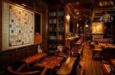 a room filled with lots of wooden furniture and bookshelves next to a bar