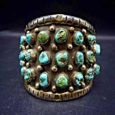 OLD VINTAGE STERLING SILVER and TURQUOISE CUFF BRACELET  DESCRIPTION:  28 specimens of natural turquoise set in a heavy gauge sterling silver cuff with applied raindrops on the oxidized finish. This bracelet will be a cherished addition to your collection of fine vintage Southwestern and Native American jewelry. MEASUREMENTS: Interior of the cuff measures 5 1/4" with an additional 1"  non-adjustable gap. Total circumference:  6 1/4" Measures 2 1/8" straight across the widest part (from wrist bon Vintage Turquoise Bangle Cuff Bracelet, Vintage Turquoise Stamped Cuff Bracelet, Rectangular Turquoise Jewelry For Collectors, Vintage Turquoise Stamped Bracelets, Vintage Patina Cuff Bracelet, Unique Turquoise Bracelets Collectible, Collectible Rectangular Turquoise Jewelry, Green Vintage Cuff Bracelet, Antique Turquoise Bangle Cuff Bracelet