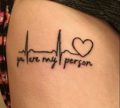 a heartbeat tattoo with the words you are my person