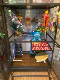 a bird cage filled with toys and other items