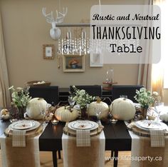 a dining room table set for thanksgiving with white pumpkins and greenery on top