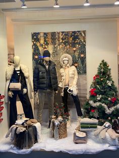 a window display with mannequins and christmas decorations