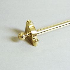 a pair of gold colored handles on a white surface