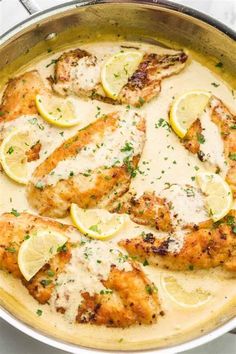 chicken with lemon sauce in a skillet on a marble countertop, ready to be eaten