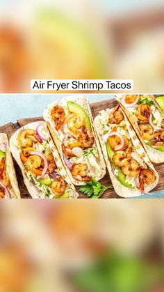 several tacos with shrimp and avocado are on a wooden platter, ready to be eaten