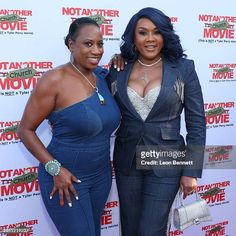 two women pose for the camera on the red carpet