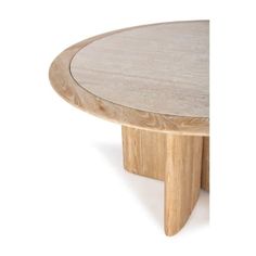 a round wooden table sitting on top of a white floor