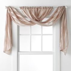 an open window with sheer curtains hanging from the top and bottom, in front of a white wall