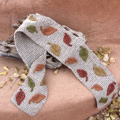 a white ribbon with leaves and nuts on it