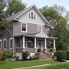 a gray house with white trim and windows