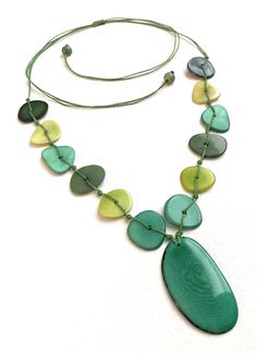 Tagua Necklace Ecuadorean Tagua Jewelry - Eco Friendly Color: Green Part Number: TAG667AG Item Weight: 1.4 Product Length: 32 inches long adjustable to shorter Earrings Length: 1 1/4 inch About Tagua This Product is handcrafted from a palm tree nut native to the lush tropical rainforests of Ecuador. Also referred to as the Ecuadorean Ivory Palm, the Tagua tree produces several bushels of seed pods a year with up to 100 Tagua nuts per pod. These nuts are then harvested, dried, and crafted into a Tagua Necklace, Tagua Jewelry, Tagua Nuts, Eco Friendly Jewelry, Seed Pods, Necklace Long, Adjustable Necklace, Aqua Green, Necklace And Earrings