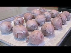 several raw meatballs on a baking sheet ready to be cooked in the oven,