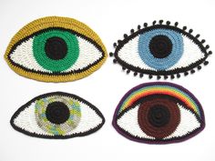 four crocheted eye patches with different colors