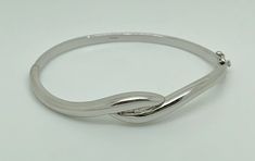 A gorgeous modern sterling silver hinged bangle bracelet in sleek minimalist design, set with a lovely brilliant cut natural earth mined diamond. Nice heavy solid weight. Maker/Markings: Marked 925 DIA for Sterling Silver & Diamond with english hallmark - ALd, 925, 925, Leopards Head (London Assay) Condition: Very Good Used Condition, general wear - Please look at photos Measurements: 6.5" inside circumference - Diamond 2mm Weight: 19.9g Modern Round Sterling Silver Bracelet For Anniversary, Modern Bangle For Anniversary, Modern Bangle With Sterling Silver Clasp, Contemporary Sterling Silver Bangle For Formal Occasions, Contemporary Sterling Silver Bangle Bracelet For Formal Events, Elegant Hinged Sterling Silver Bracelet, Elegant Hinged Sterling Silver Bangle Bracelet, Minimalist Hallmarked Sterling Silver Bracelet, Elegant Sterling Silver Hinged Bangle