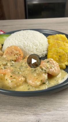 a plate with shrimp, rice and vegetables on it