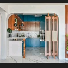 an open kitchen with blue cabinets and marble counter tops