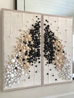 two pieces of art made out of wood and white paint with black dots on them