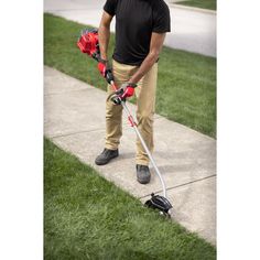 a man is standing on the sidewalk with his crutches and helmet in hand