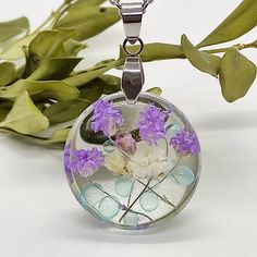 The pendant is made with real flowers cast in UV-protected resin, to ensure the piece stays clear for decades. The stainless steel chain will not rust, tarnish or fade. All materials used are hypo-allergenic. Pendant Size: 25*25 mm Every order comes in a small gift box; ready for gifting. More pressed flower necklaces: https://www.etsy.com/shop/FancyNatural?ref=seller-platform-mcnav&section_id=26442625 I accept payments through Paypal (you no need to have an account) by credit or debit card Than Resin Necklace With Pressed Flowers In Round Pendant, Round Resin Pendant Necklace With Pressed Flowers, Resin Necklace With Pressed Flower Pendant, Silver Resin Necklaces With Pressed Flowers, Dried Flower Jewelry, Flower Necklaces, Purple Wildflowers, Terrarium Jewelry, Terrarium Necklace