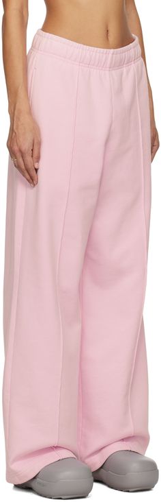 French Terry sweatpants. · Concealed drawstring at elasticized waistband · Two-pocket styling · Logo embroidered at front · Pinched seams at legs Supplier color: Baby pink Pink Wide Leg Sweatpants Athleisure Style, Pink Wide Leg Athleisure Sweatpants, Pink Sweatpants With Pockets, Wide Leg, Pink Wide-leg Sweatpants With Pockets, Pink Wide Leg Sweatpants With Pockets, Pink Relaxed Fit Sweatpants, Pink Cotton Pants With Elastic Cuffs, Pink Bottoms With Elastic Cuffs For Spring, Pink Wide Leg Joggers For Spring