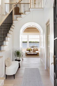 an entry way with stairs and a couch in the center, along with a rug on the floor