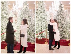 a man and woman standing in front of a christmas tree talking to each other while holding hands