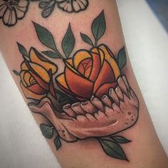 a skull with roses on it's arm