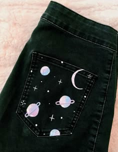 a pair of black jeans with space and planets on them