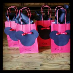 some pink and blue bags with minnie mouse ears on them