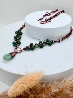 The Green Aventurine Antiqued Copper necklace marries elegance with vintage charm, exuding a timeless allure that captivates admirers. Crafted with meticulous attention to detail, this necklace intertwines the soft, soothing hues of green with the rustic allure of antiqued copper. The natural variation in the stones adds a touch of uniqueness to every piece, making the necklace a one-of-a-kind treasure. The beads are carefully strung along a durable yet flexible wire, allowing for comfortable wear and graceful movement.  The antiqued copper accents infuse the necklace with a sense of old-world charm and sophistication. The weathered finish lends a distinctive character to the piece, reminiscent of heirloom jewelry passed down through generations. Intricate copper detailing, meticulously cr Oxidised Necklace, Graceful Movement, Heirloom Jewelry, Copper Jewellery, Oxidized Necklace, Copper Accents, Heirlooms Jewelry, Necklace Gemstone, Copper Necklace