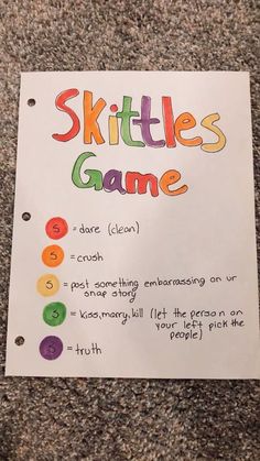 a paper sign that says skittles game on it's front and back sides