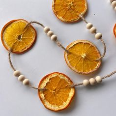 orange slices are strung with string and beads