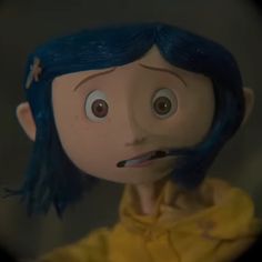 an animated doll with blue hair is shown through a magnifying glass window, looking at the viewer